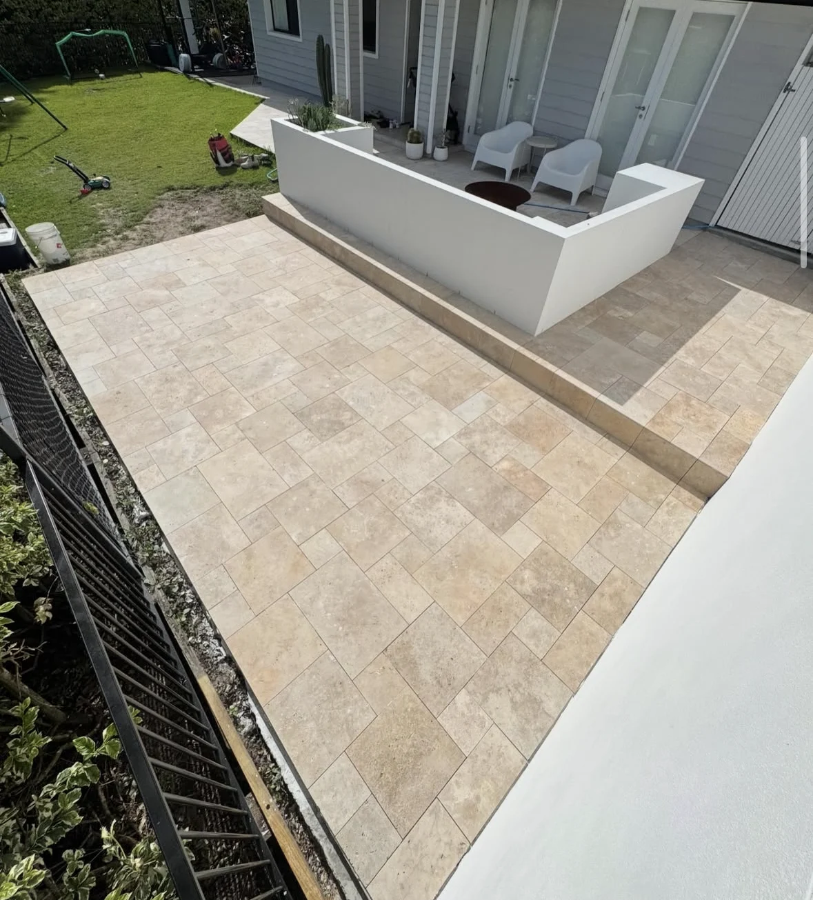 French pattern tiled patio stepping around a white outdoor seating area in Currumbin