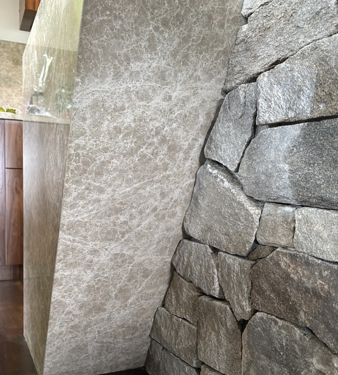 Close-up of a smooth benchtop edge meeting the textured natural stone face